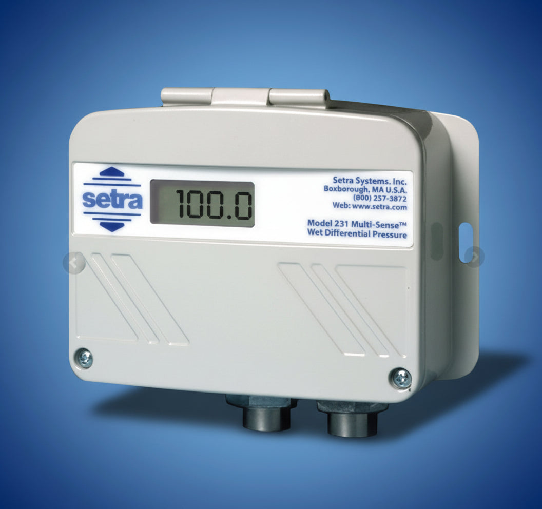 Setra differential pressure sensor with digital display on a blue background