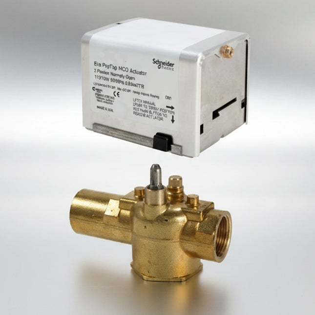 Brass valve and white rectangular box with Schneider Electric branding on a white background