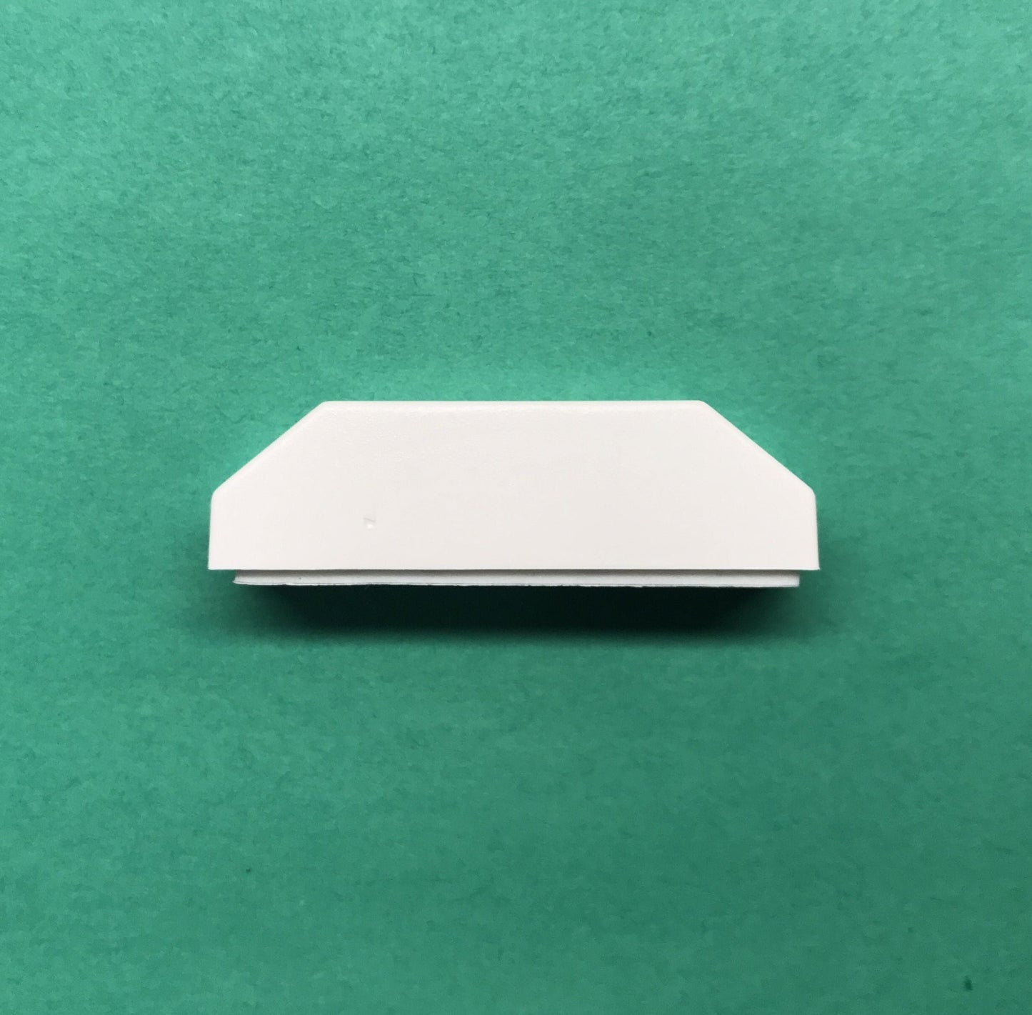 White rectangular object on a green background