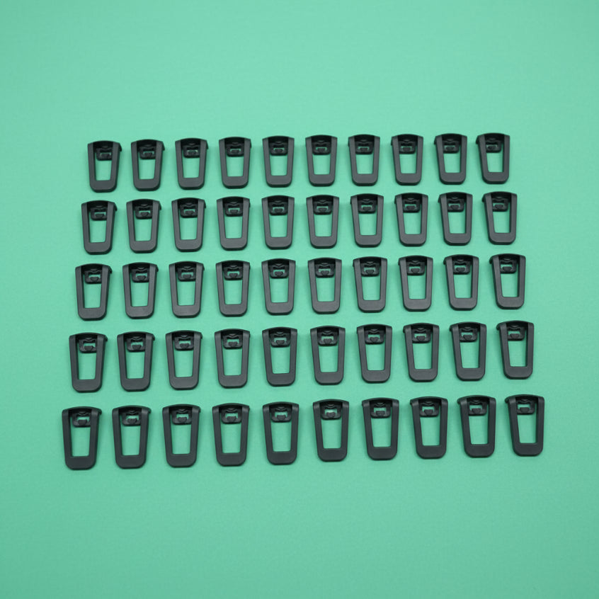 Black clips on a green background