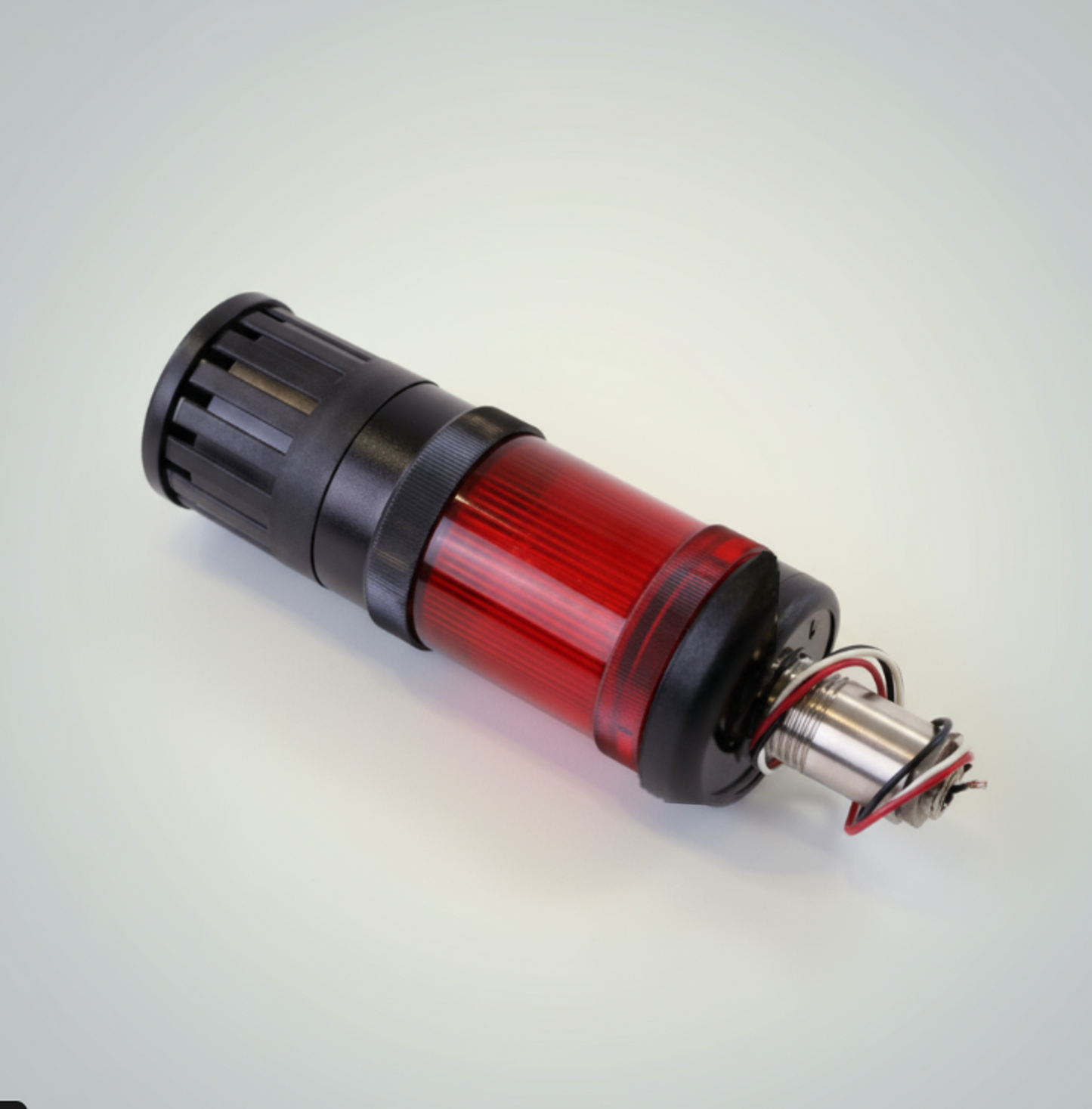Cylindrical mechanical component with red and black design on a light gray background