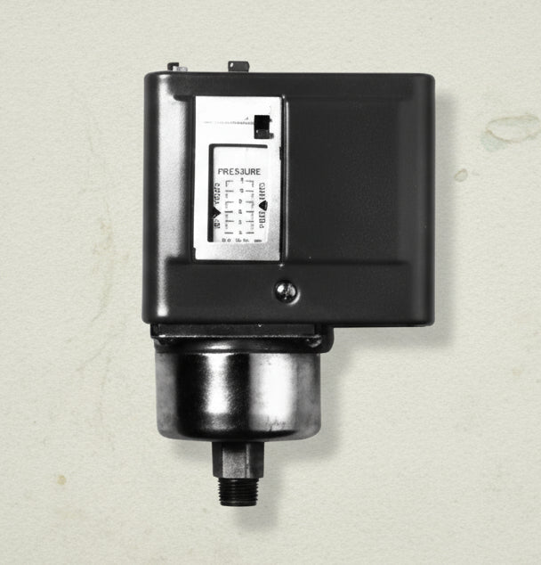 Black mechanical device with a digital display on a white background