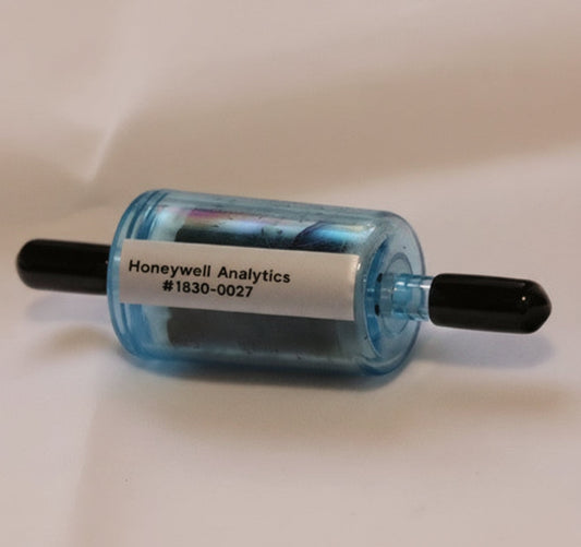 Honeywell small cylindrical freon filter with tips on a white tan background