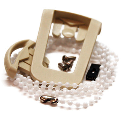 Gold buckle with white beads and small black and gold screws on a white background