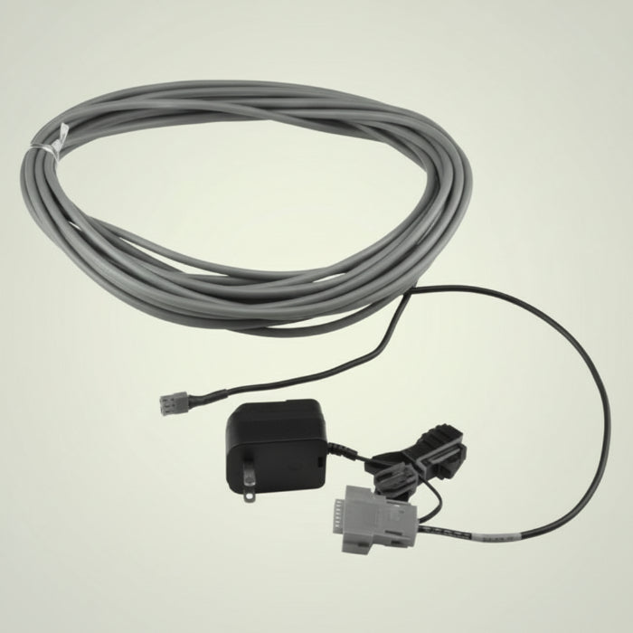 Cable with connectors and a small device on a white background