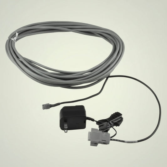 Cable with connectors and a small device on a white background
