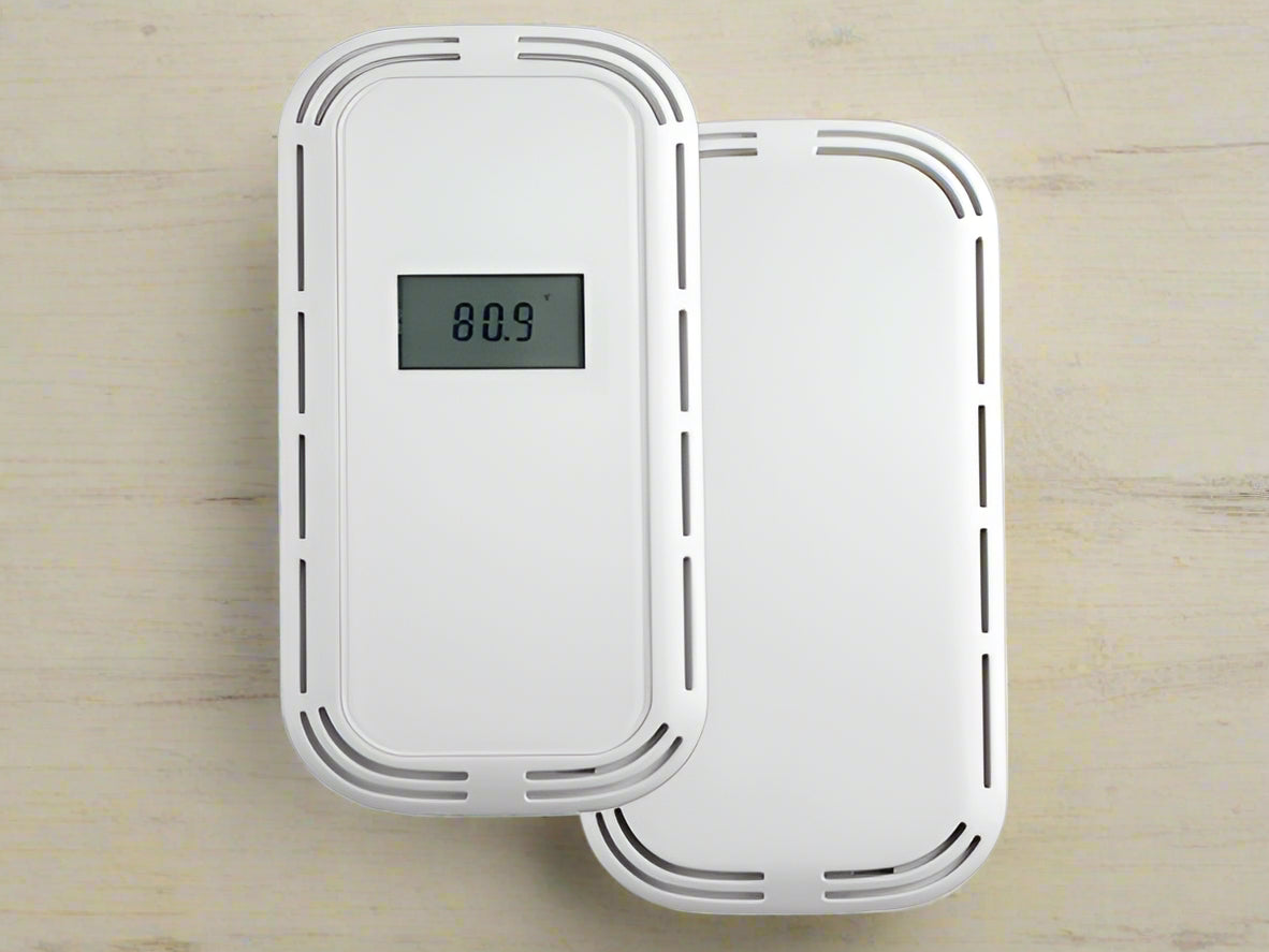White electronic device with digital display on a tan background