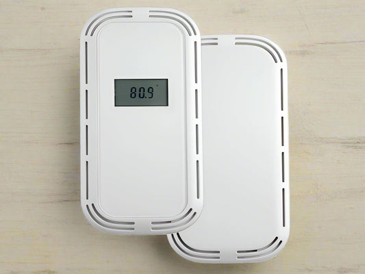 White electronic device with digital display on a tan background