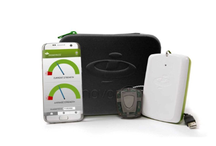 Black hard case with wireless survey kit components and a smart phone displaying the app. 