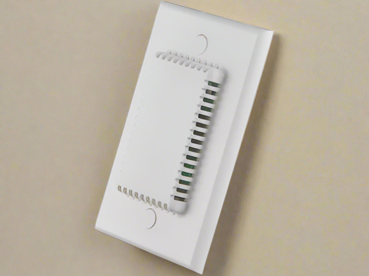 White wall-mounted sensor on a tan background