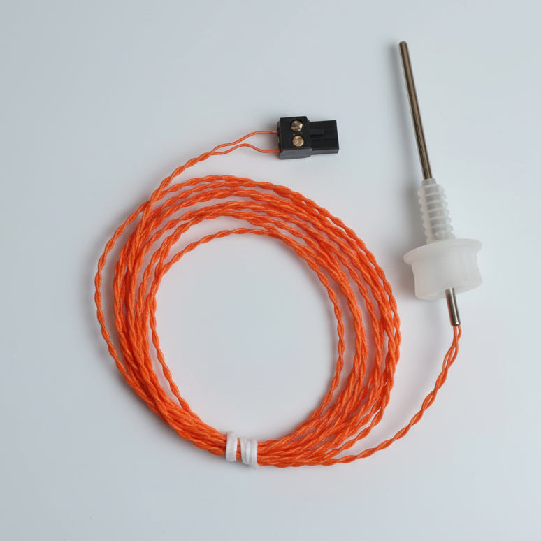 Thermocouple with orange cable on a white background