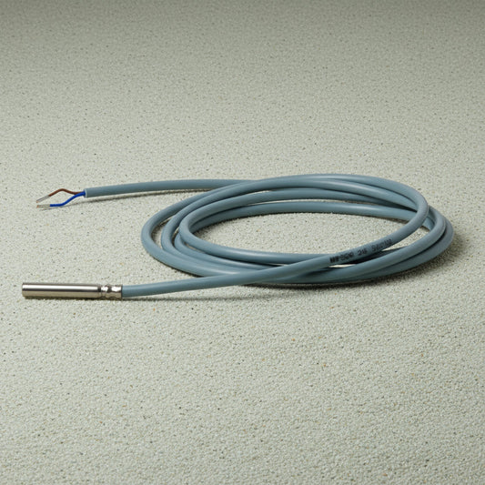 Coiled cable with a metal connector on a white background