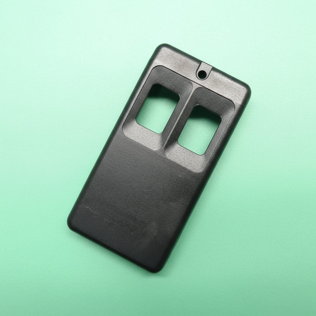 Black plastic housing with two button holes on a green gradient background