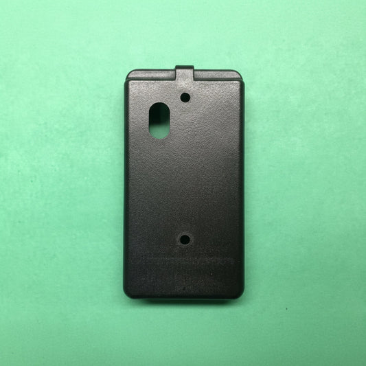Black plastic case on a green background