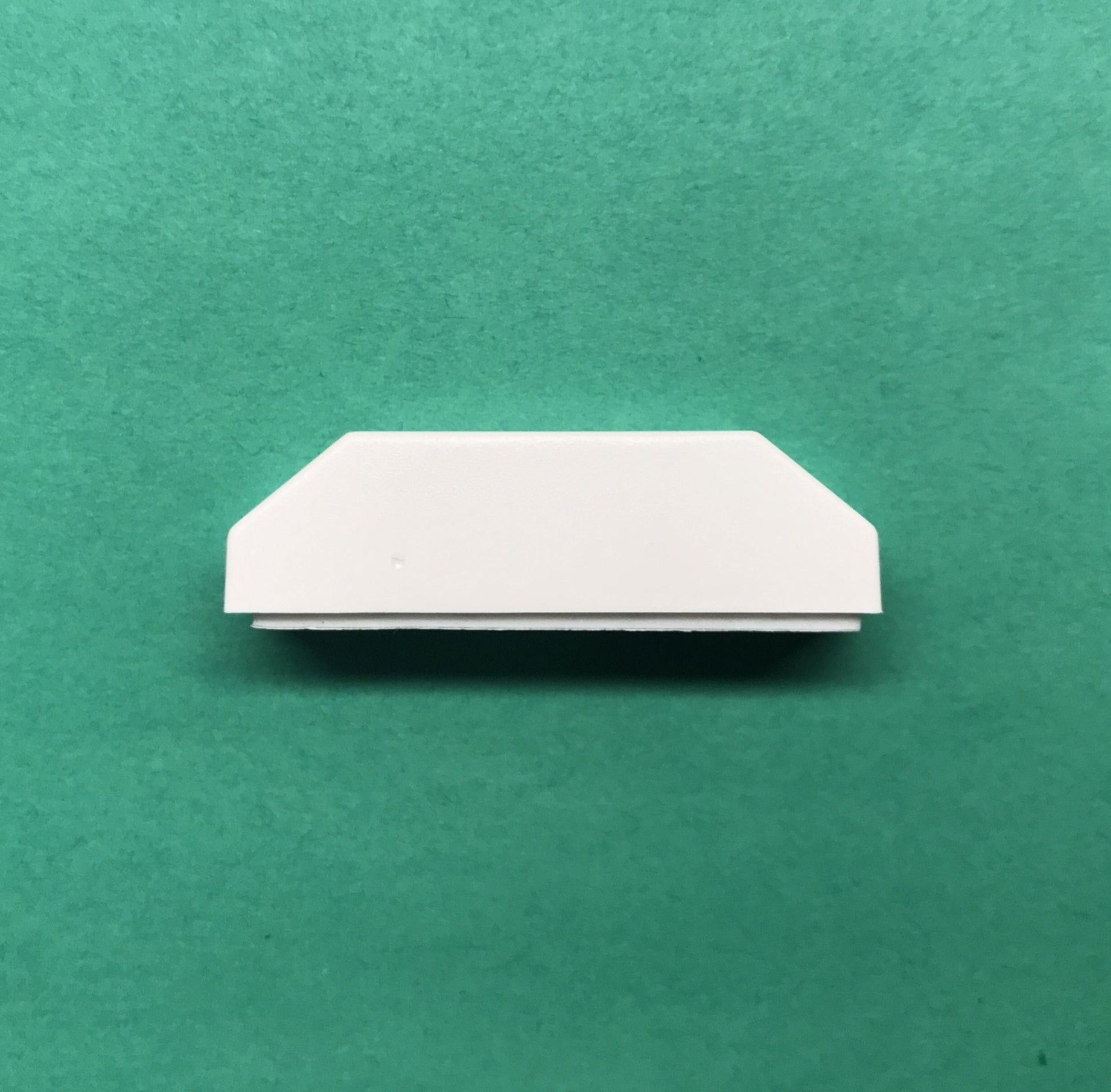 White rectangular object on a green background
