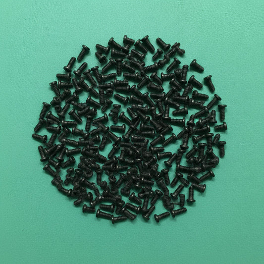 Small black screws on a green background