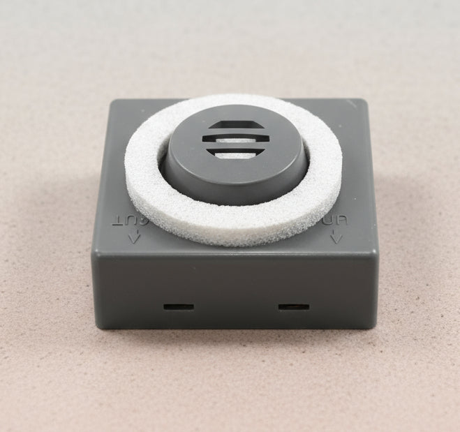 Square device with a circular component on a gray background