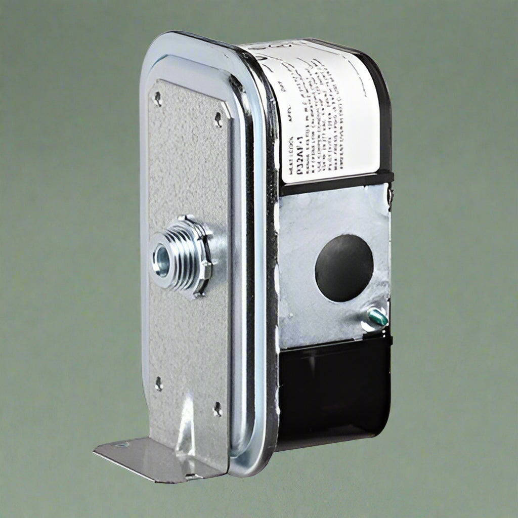 Metallic pressure switch mechanism on a green background