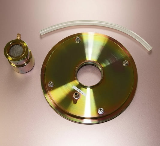 Gold-colored metal component with a white tube on a white background